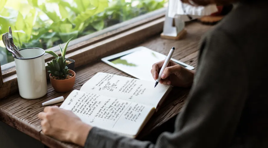 A person writing notes in a notebook