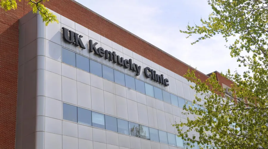 A close up of a silver building with the words "UK Kentucky Clinic" in black on it.