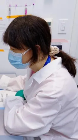 Xia Liu working at a lab computer.