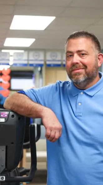 Barry Pendleton leaning on exercise machine