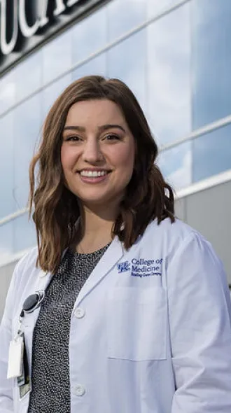 Anna Cox standing in front of the Medical Education building on Bowling Green's campus.