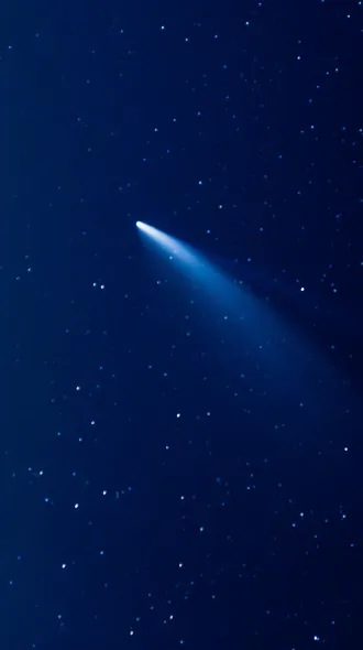 A silvery comet shooting through the night sky.