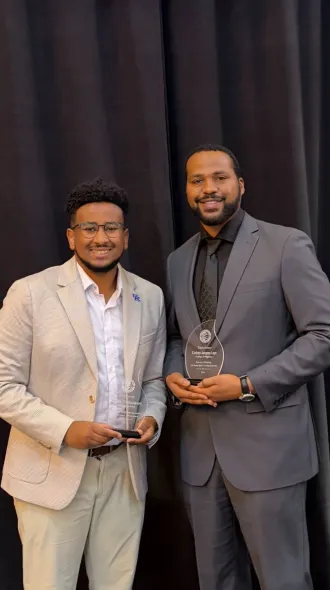 Kidus Shiferawe (left) and Cortney Laye (right) pose with their awards