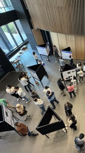 An overhead shot of the 10th annual Neuroscience Symposium, showing individuals conducting poster presentations.