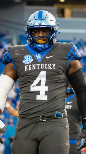 Josh Paschal on the football field in his UK gear. A large number 4 is on his jersey.