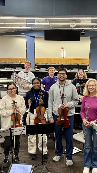 Members of the medical orchestra pose for a photo after practice. 