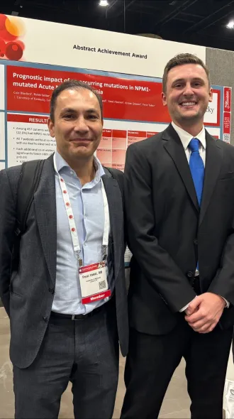 Dr. Yalniz, Blandford, and Safdar stand in front of their abstract posters