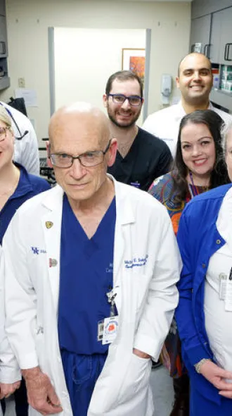 The Multidisciplinary Endocarditis Team poses in their white coats