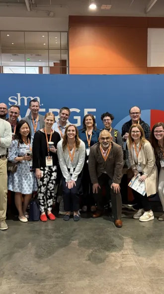 A group of attendees smile for a photo