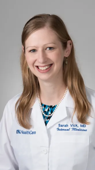 Headshot of Dr. Sarah Vick in a white coat