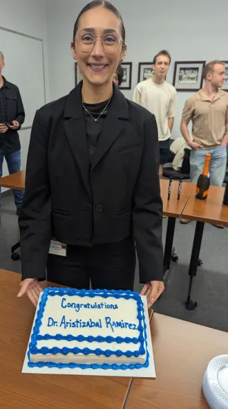 Dr. Aristizabal Ramirez displays her congratulatory cake. 