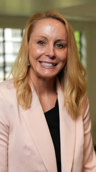 Woman blonde hair, pink blazer and black blouse