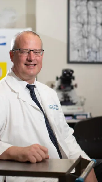 Image of Dr. Nelson sitting at a desk