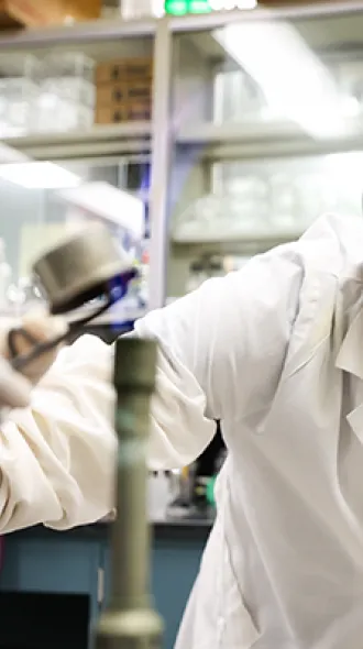 Young woman wearing goggles in lab environment