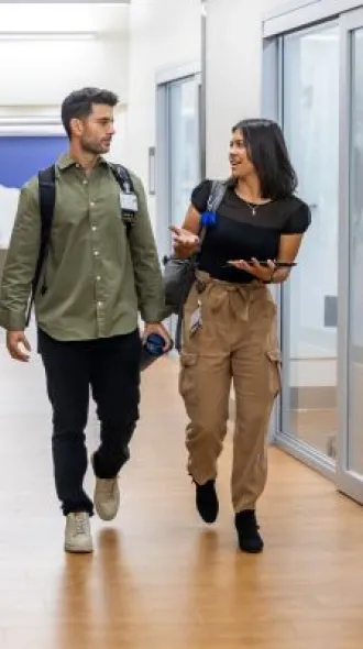 Two UK College of Medicine students walk in the M73 library