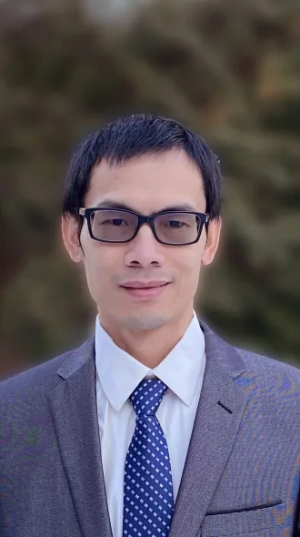 Headshot of Qingzhang Zhu in a gray suit