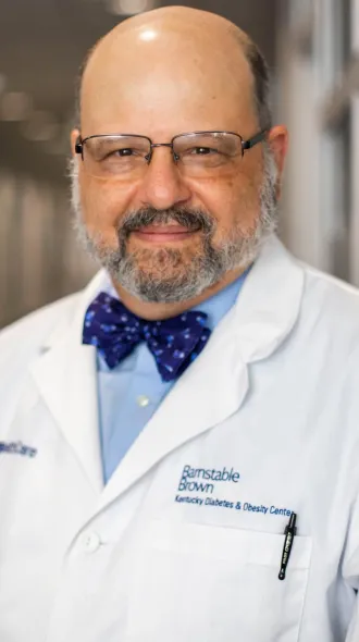 Dr. Whiteheart wearing a bowtie and white coat that reads Barnstable Brown Diabetes Center 